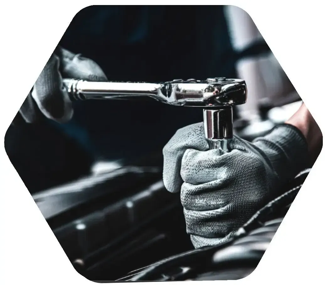 Technician using a socket wrench for precise engine service